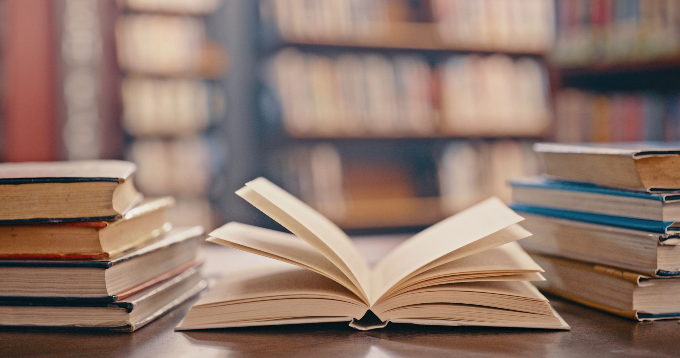 Open books on a table in a library setting