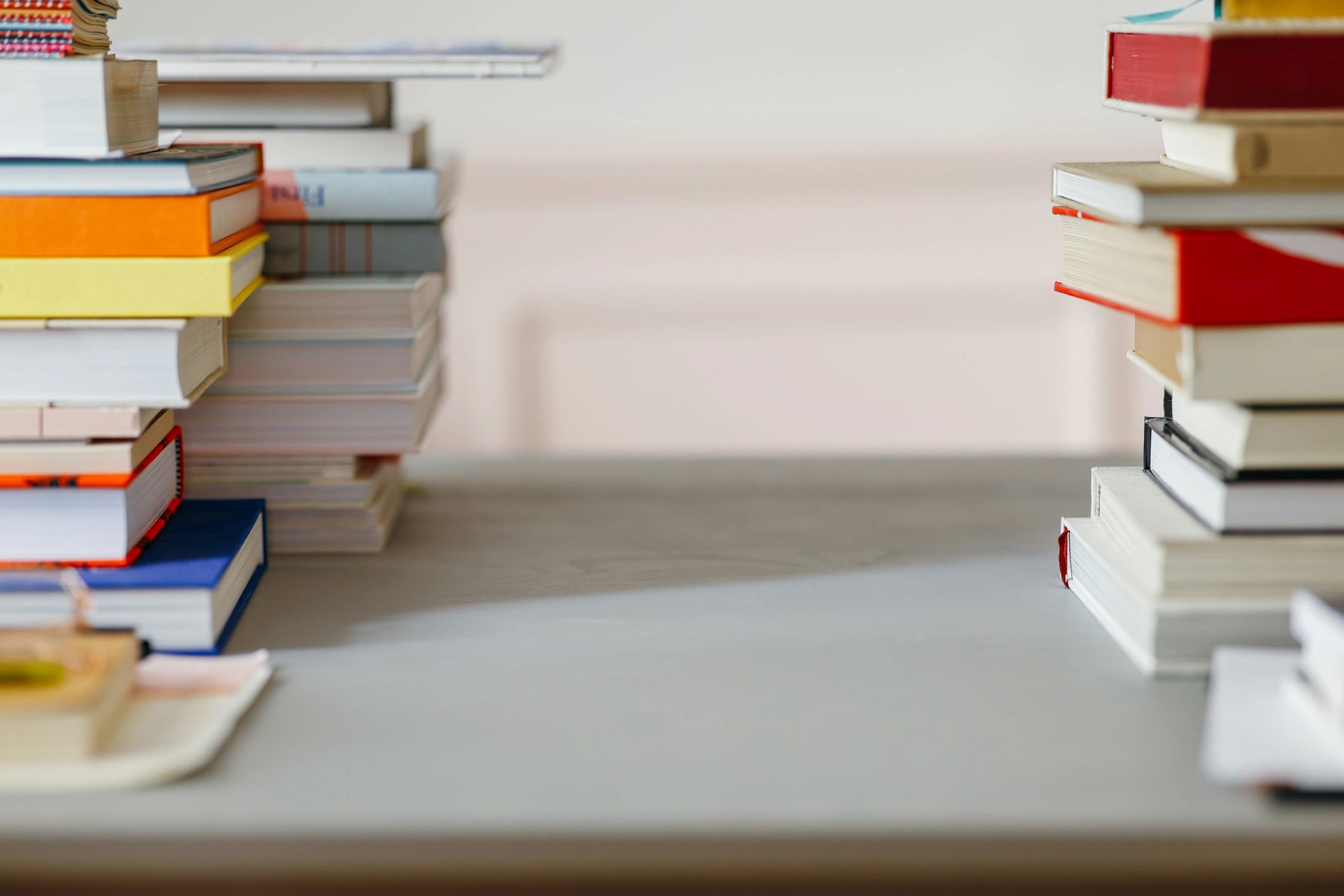 Desk with stacks of books and workspace