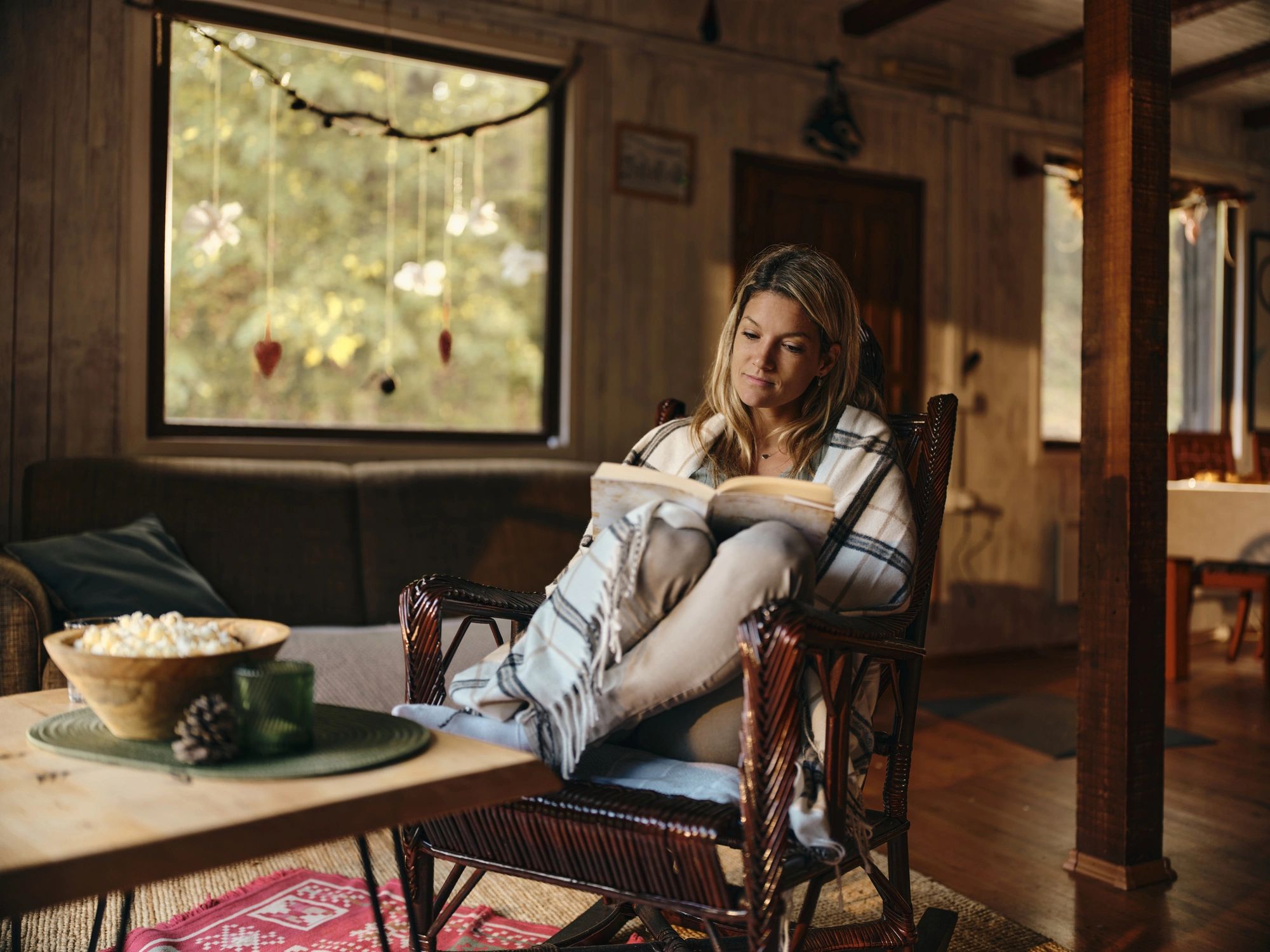 Person relaxing and reading a book at home